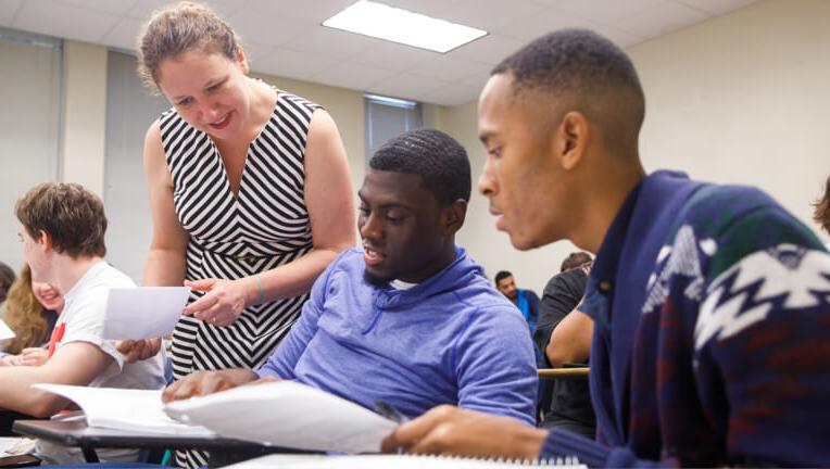 Teacher working with students